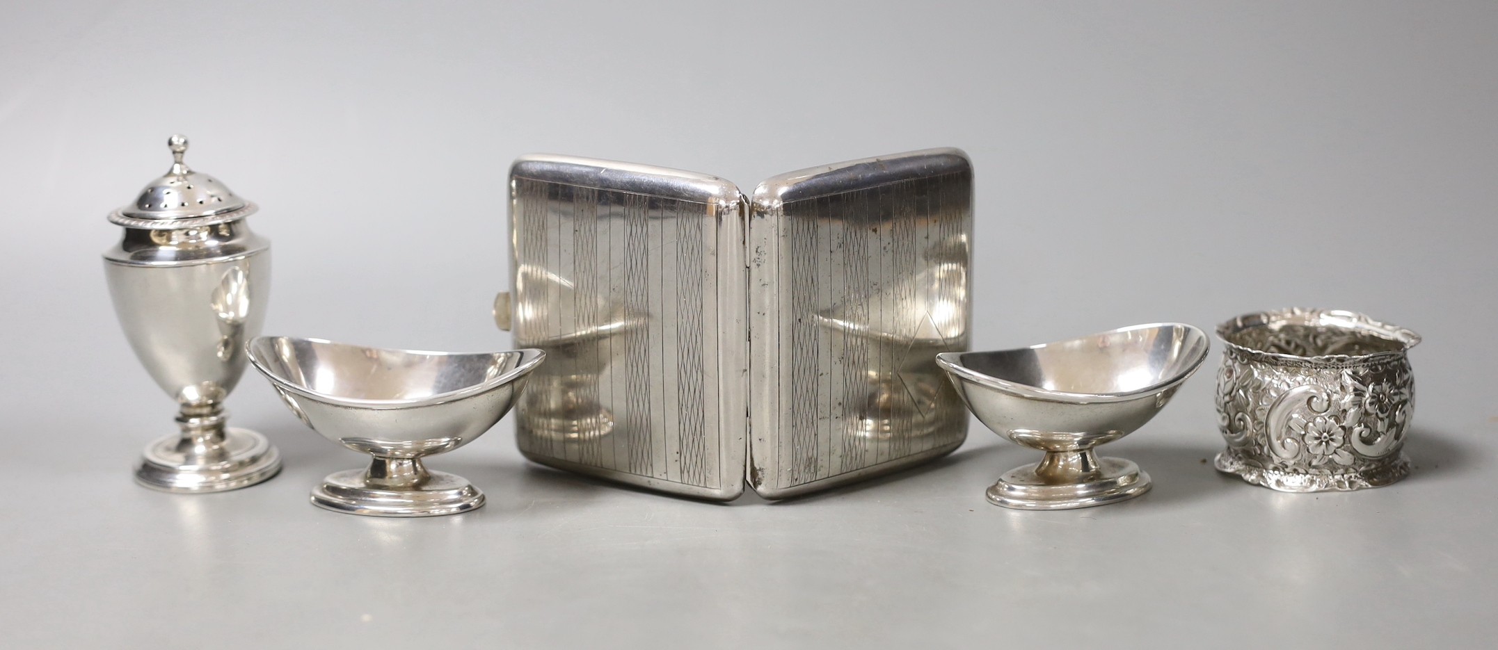 A white metal cigarette case and small silver including a pair of salts, condiment and napkin ring.